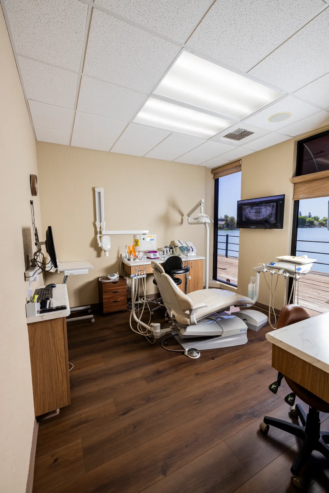 Private treatment room with a lake-view window and chairside monitor