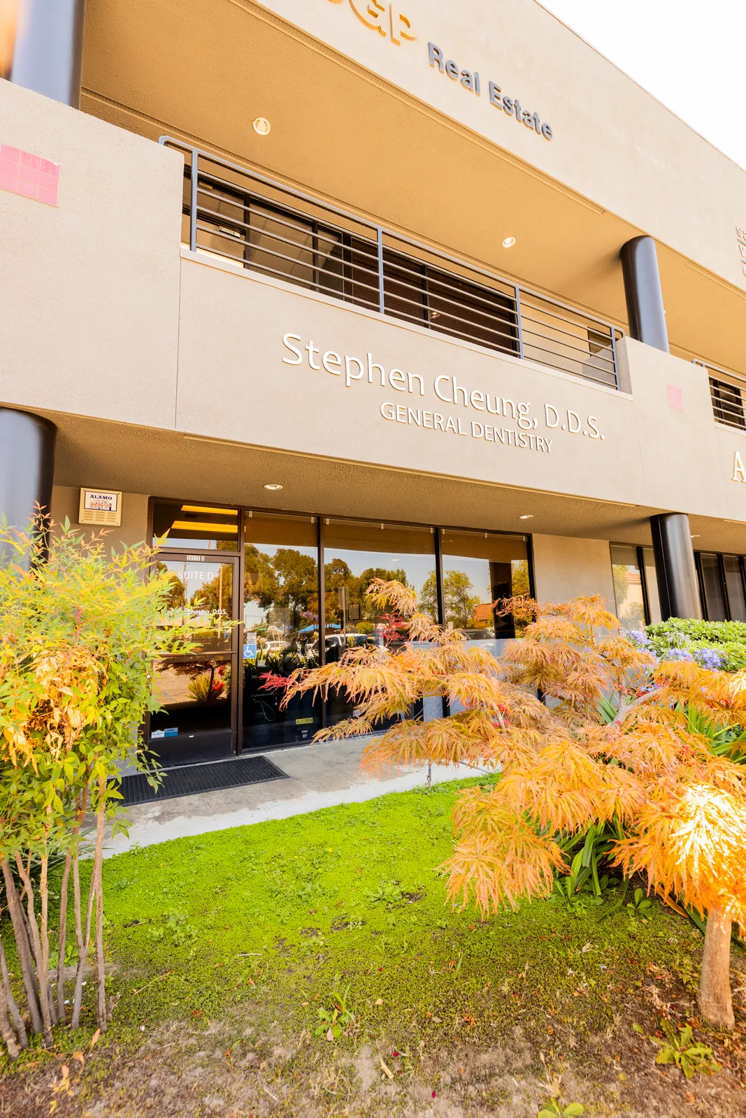 Office exterior with Stephen Cheung DDS signage and autumn landscaping